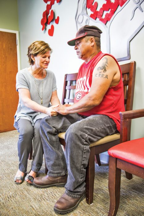 Dr. Nancy Stanley praying with a Mercy Ministries patient, Geraldo Lira, before his appointment