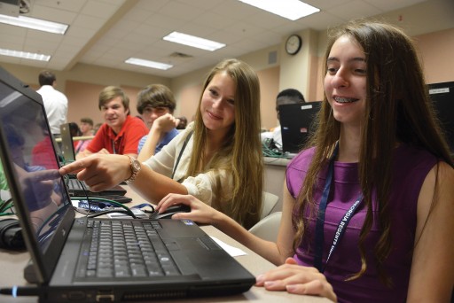 Rebecca Helling , center, explores the cyber sciences with fellow attendees.