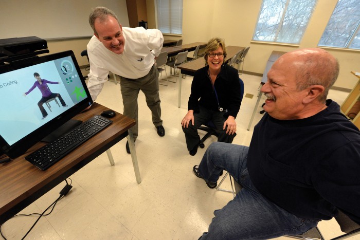 Drs. Paul York and Charlotte Chatto watch as Joe Kelley exercise using the motion-capture software.