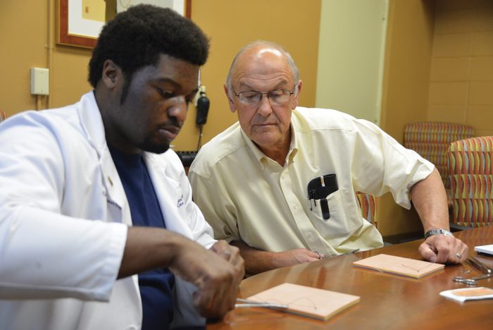 Dr. Bill Pannell (right) works with an MCG student at the Southwest Campus offices in Albany. 