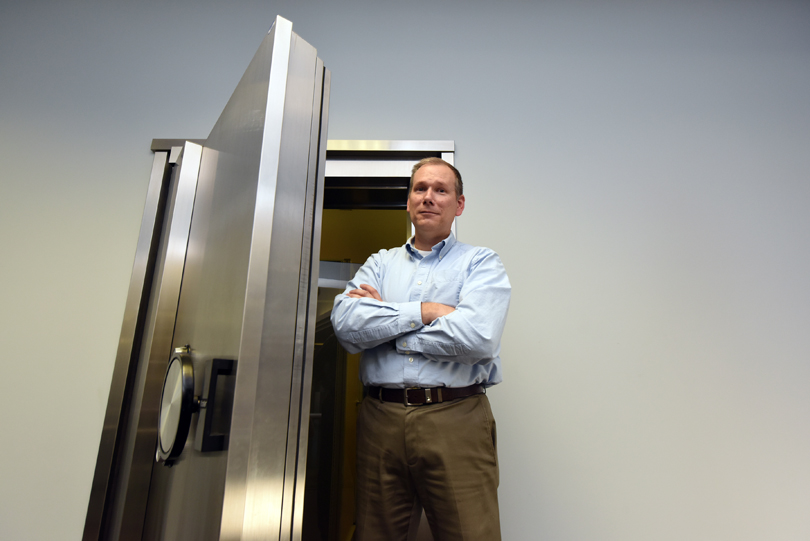 Michael Nowatkowski stands by a safe door