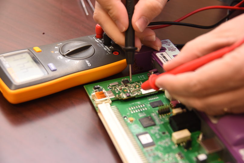 close up of hands working on medical device