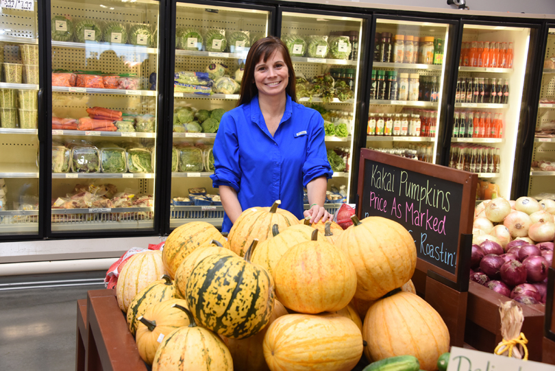 Dr. Maleah Holland poses with ketogenic diet-friendly foods at Good Earth Produce & Garden Center.